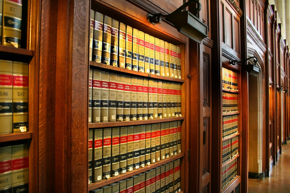 Photo of a library with bookshelves full of reference books.